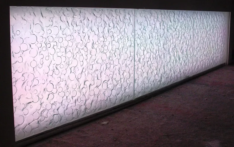 Backlit textured relief glass counter panel with a circle and crack pattern
