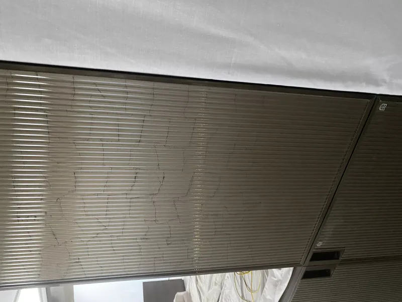 Bronze-tinted reeded glass panel in a metal frame during interior fit-out