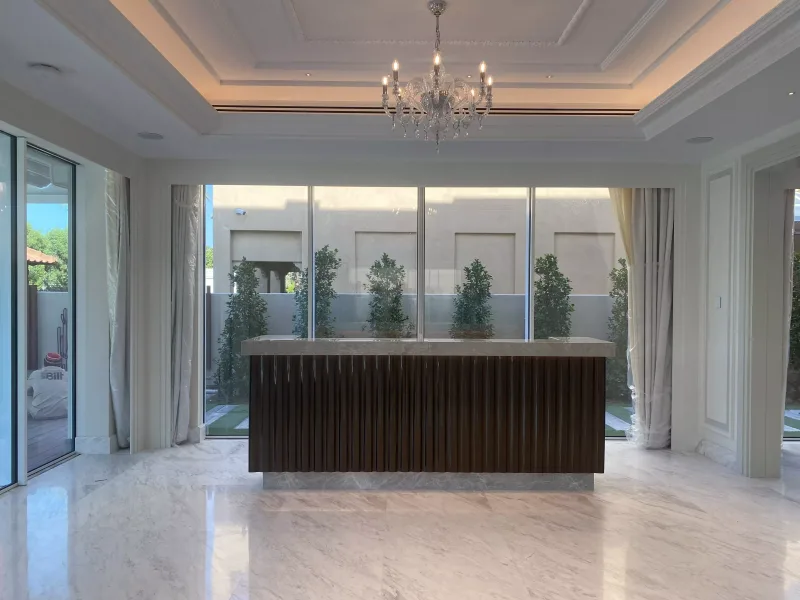 Fluted smoked glass island counter with marble top in a villa living space
