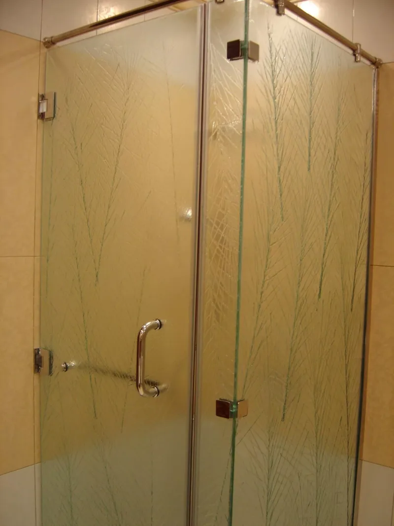 Frameless corner shower glass with fine branch-pattern texture and chrome hardware